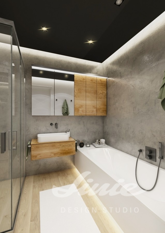 Moderní koupelna s velkou vanou a dřevěnými skříňkami