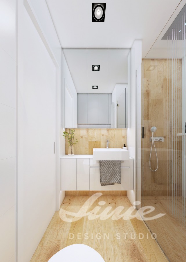 Moderní koupelna zařízena v bílých odstínech s dřevěnými prvky